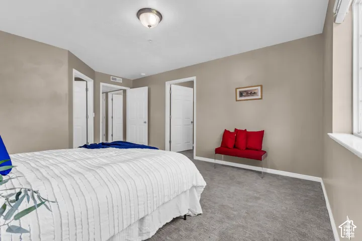 Neutral-toned walls complement the gray carpeting