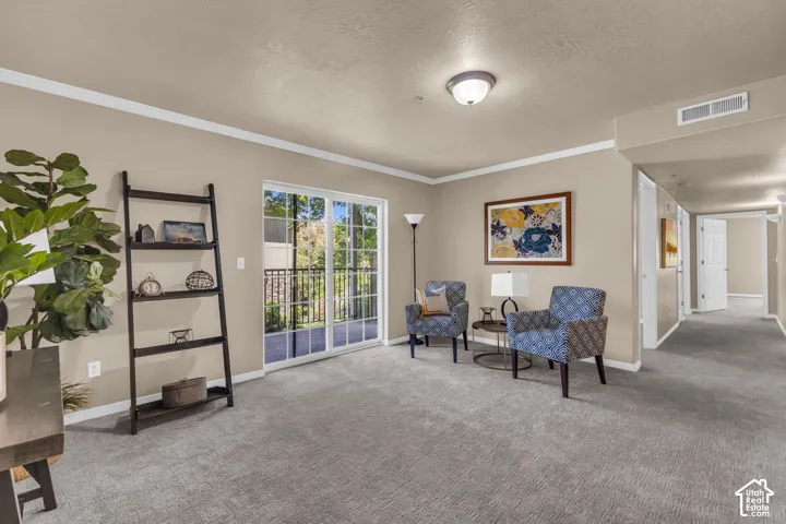 Living area featuring a sliding glass door with balcony access
