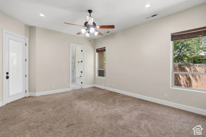Carpeted room featuring a ceiling fan with light fixture, recessed lighting, and white baseboards