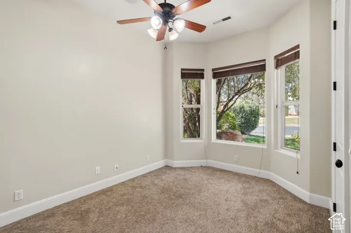 Bay window with three pane windows and dark roller shades