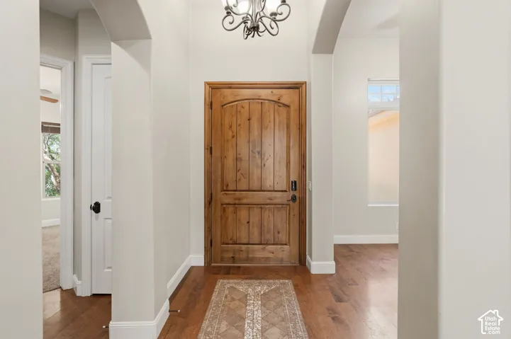 Grand entry foyer featuring a solid wood door with an arched top panel