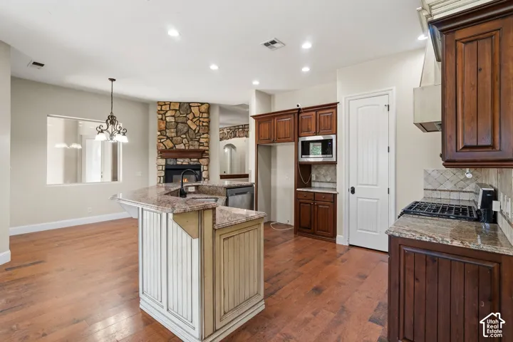 Gourmet kitchen with a large island featuring a built-in sink and seating overhang