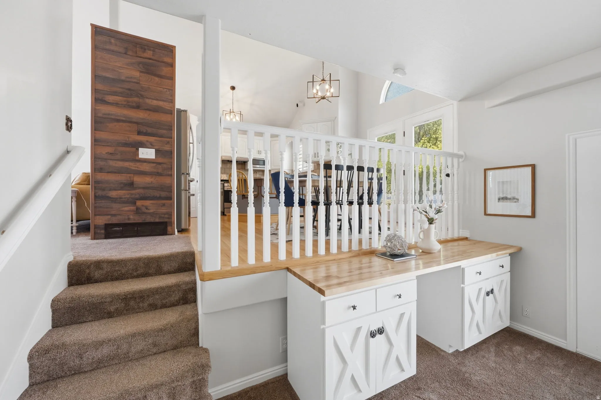 Built-in desk with wood-finish countertop and white cabinetry with X-detail doors