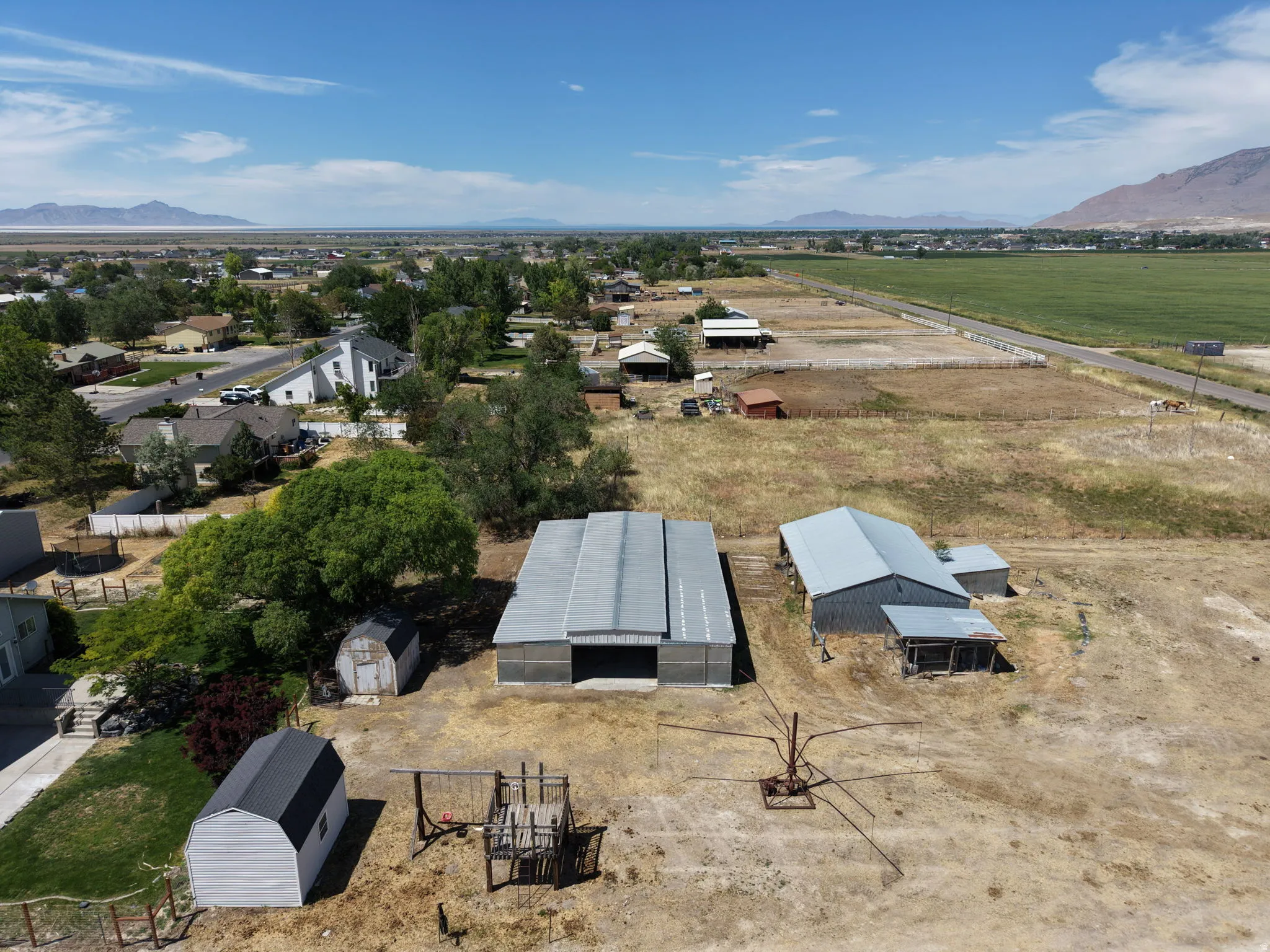 Expansive property featuring multiple outbuildings, including two large metal-roofed structures