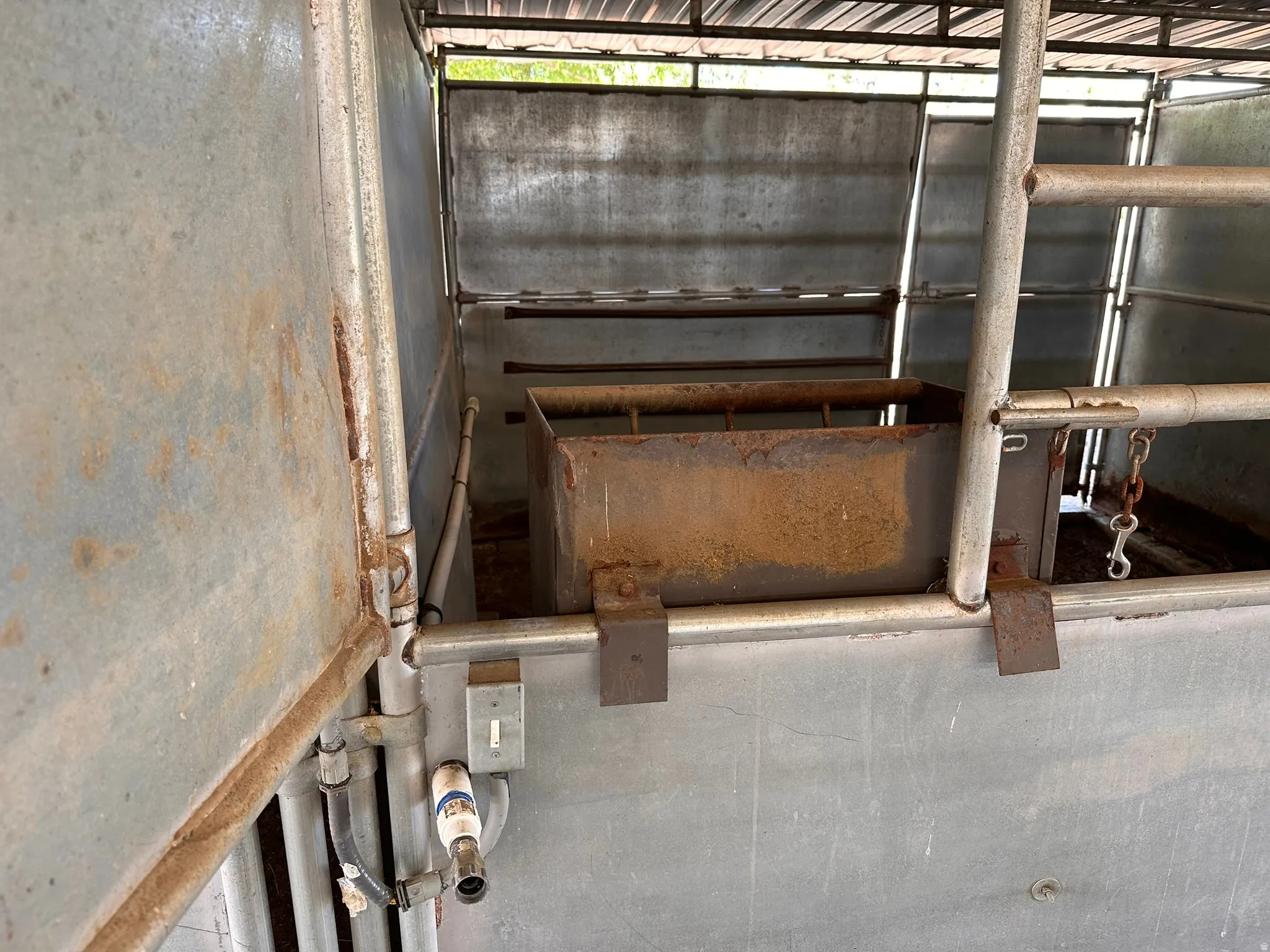 Enclosed metal structure featuring a corrugated metal roof and galvanized steel panels