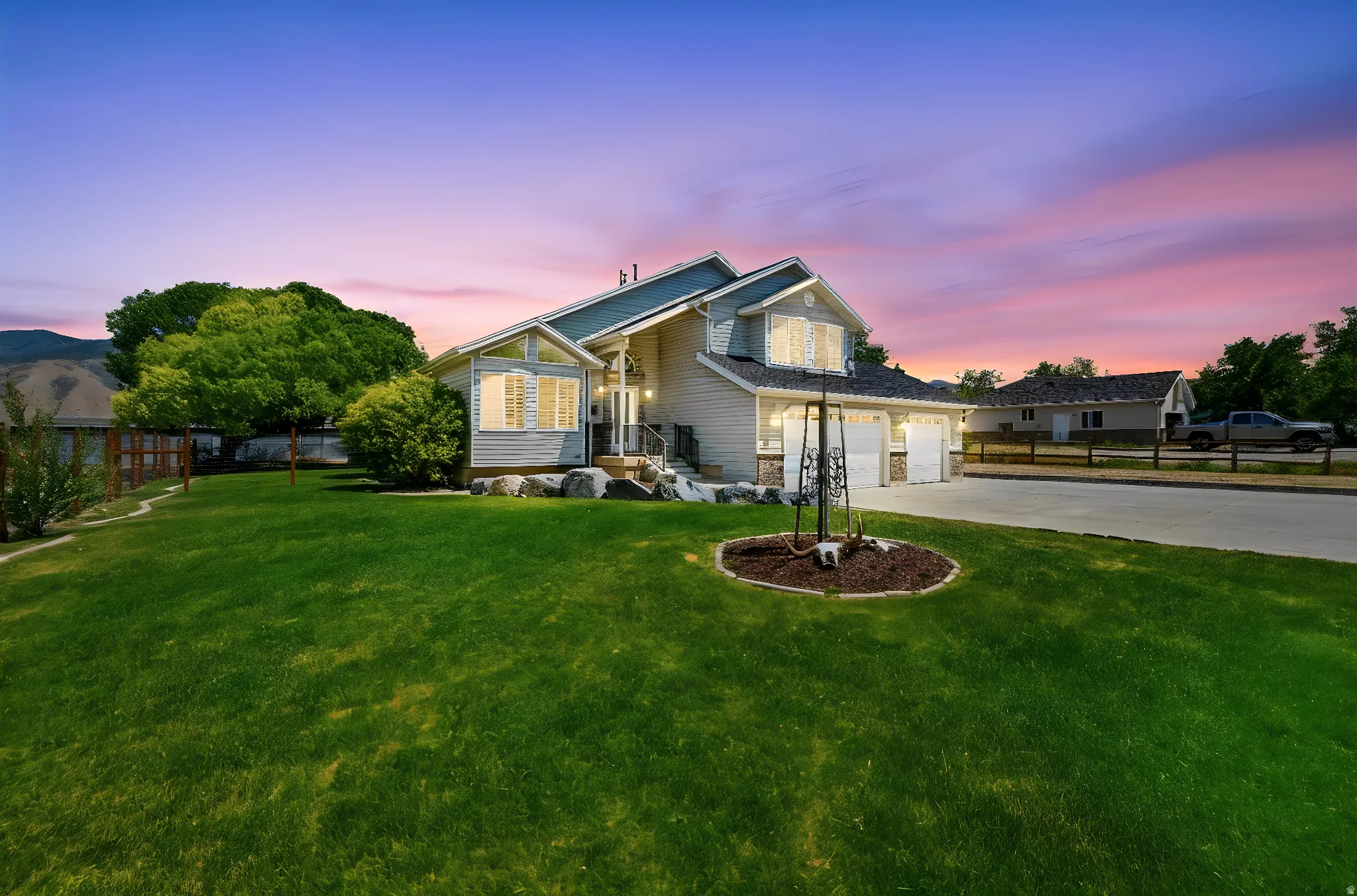 Spacious front yard with mature landscaping and a well-maintained lawn
