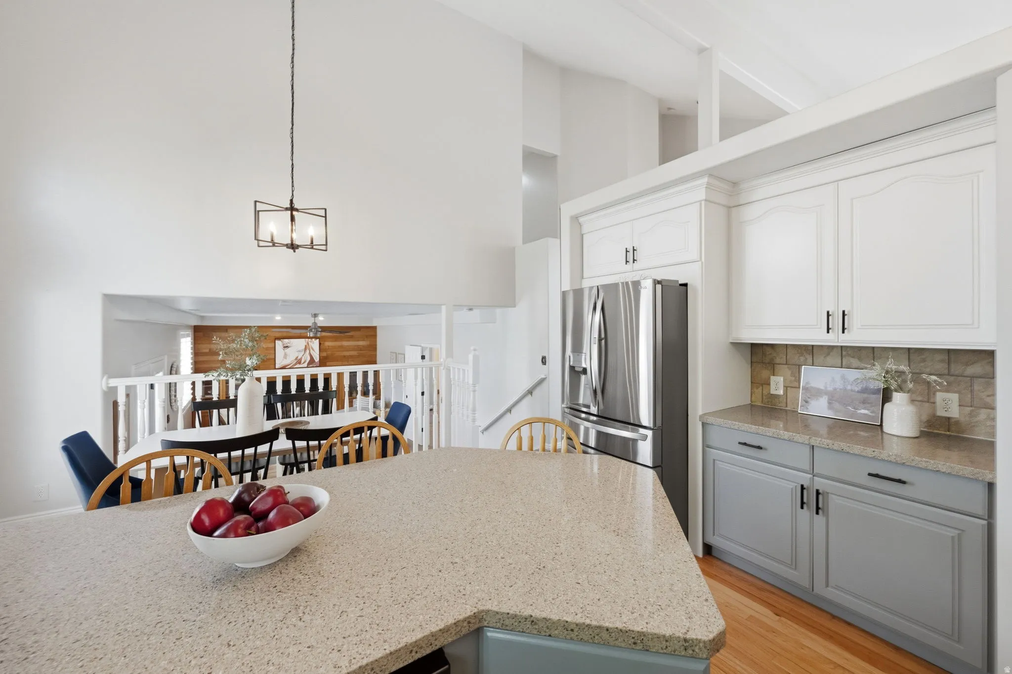 Kitchen island featuring a light-colored solid surface countertop
