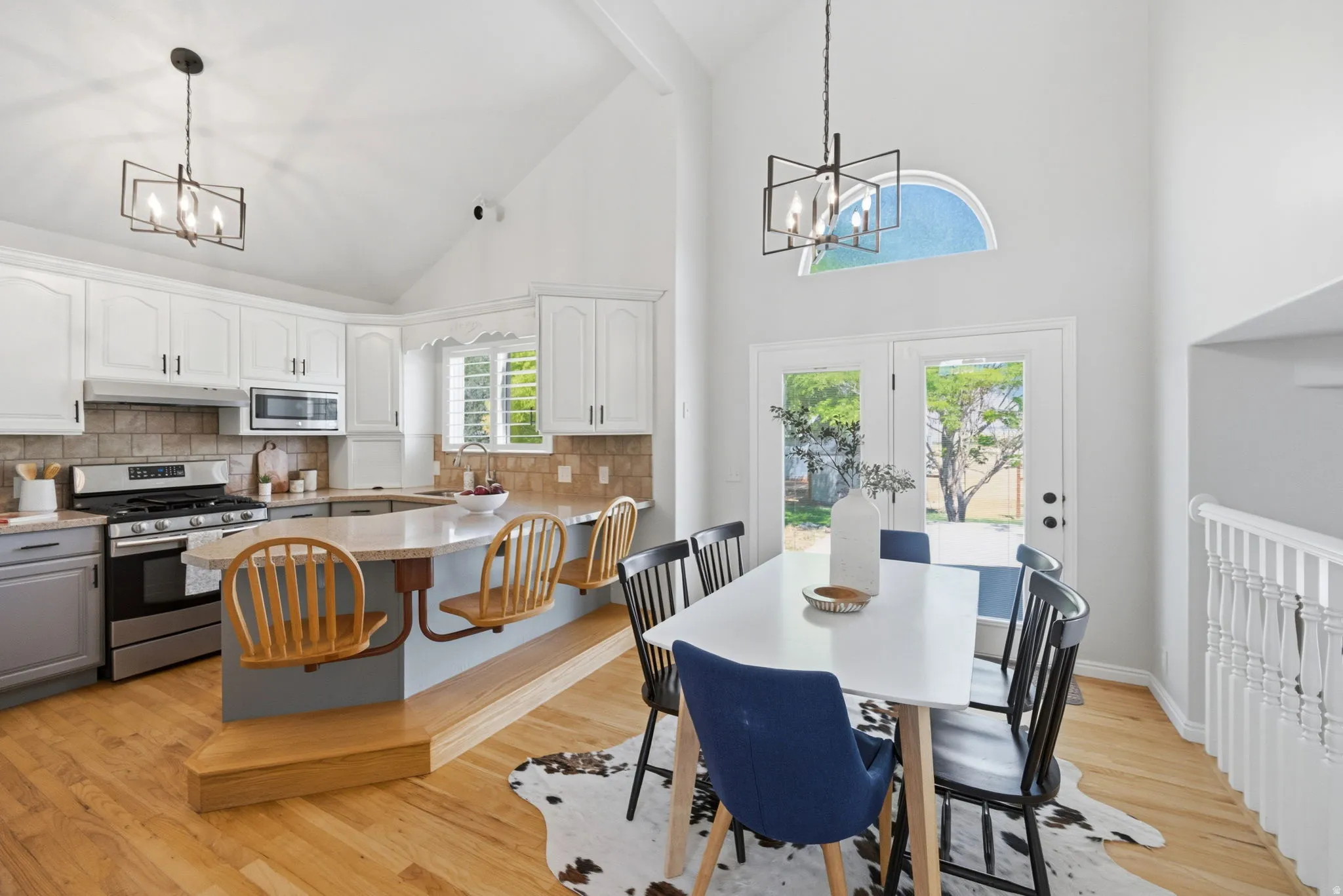 Vaulted ceilings define this open-concept kitchen and dining area