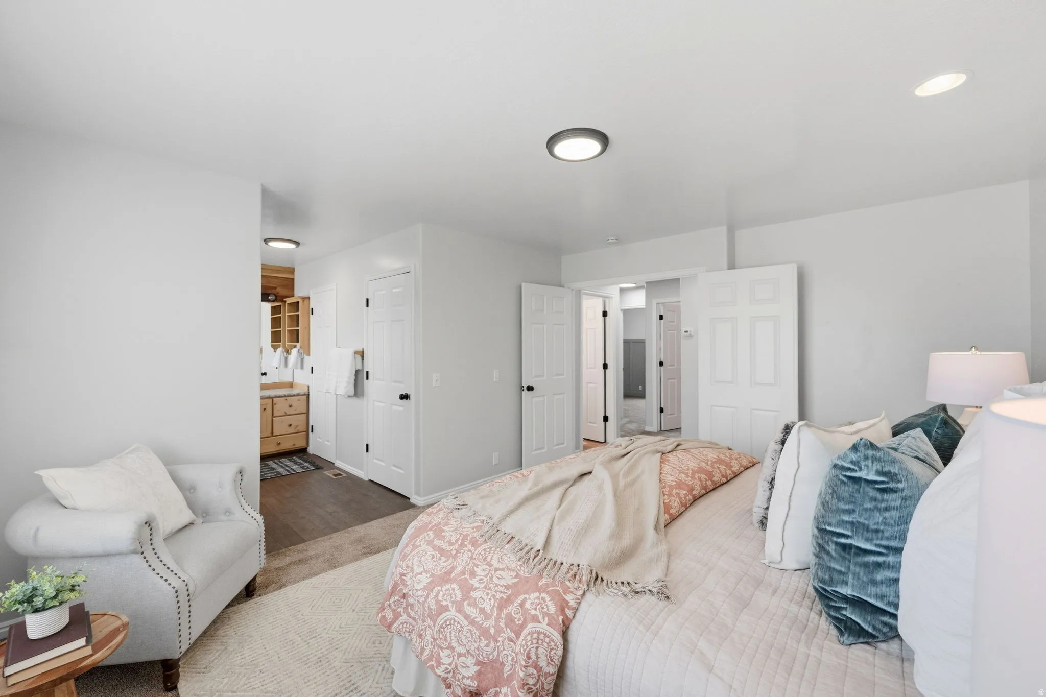 Bright interior space featuring light-colored walls, recessed ceiling lighting, and wood-finish flooring
