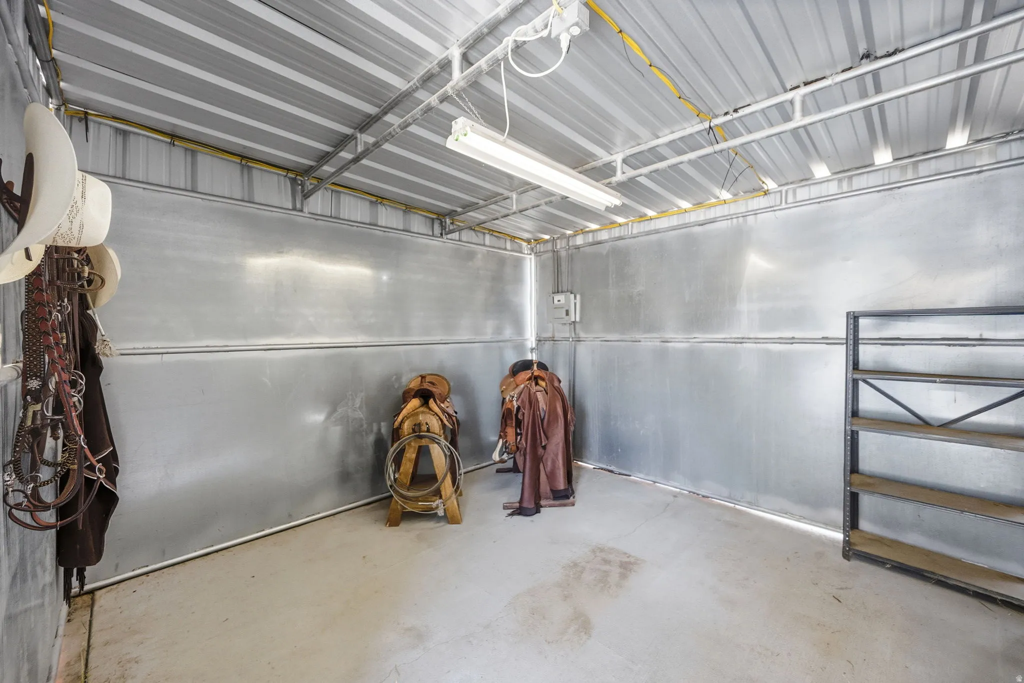 Enclosed structure featuring corrugated metal walls and ceiling