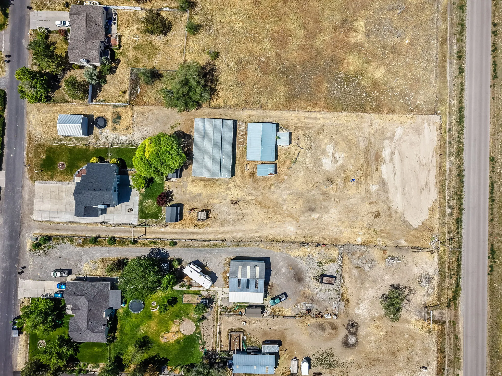 Aerial view highlighting an expansive residential property with several outbuildings