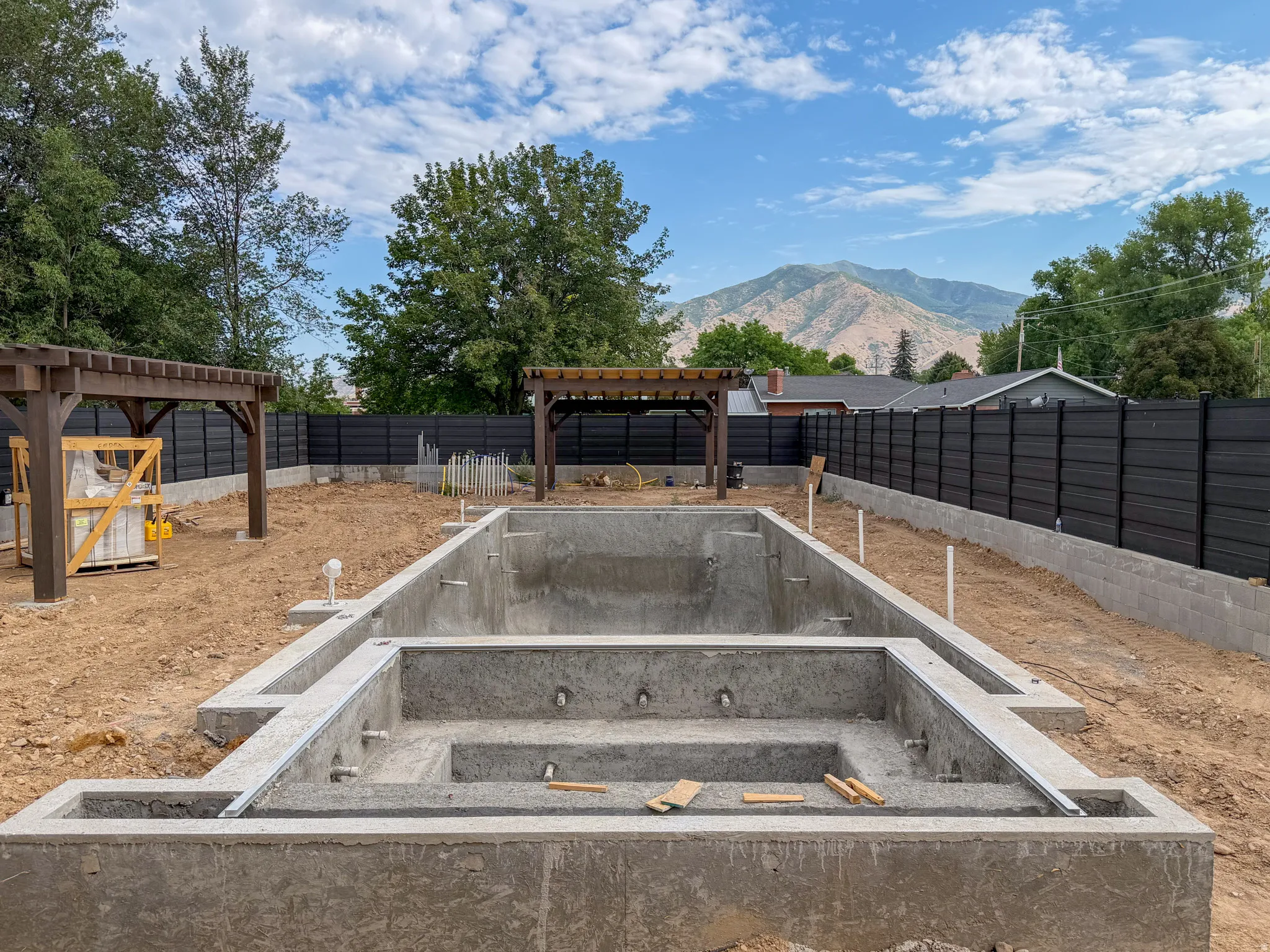 Concrete pool shell with integrated spa featuring multiple entry steps