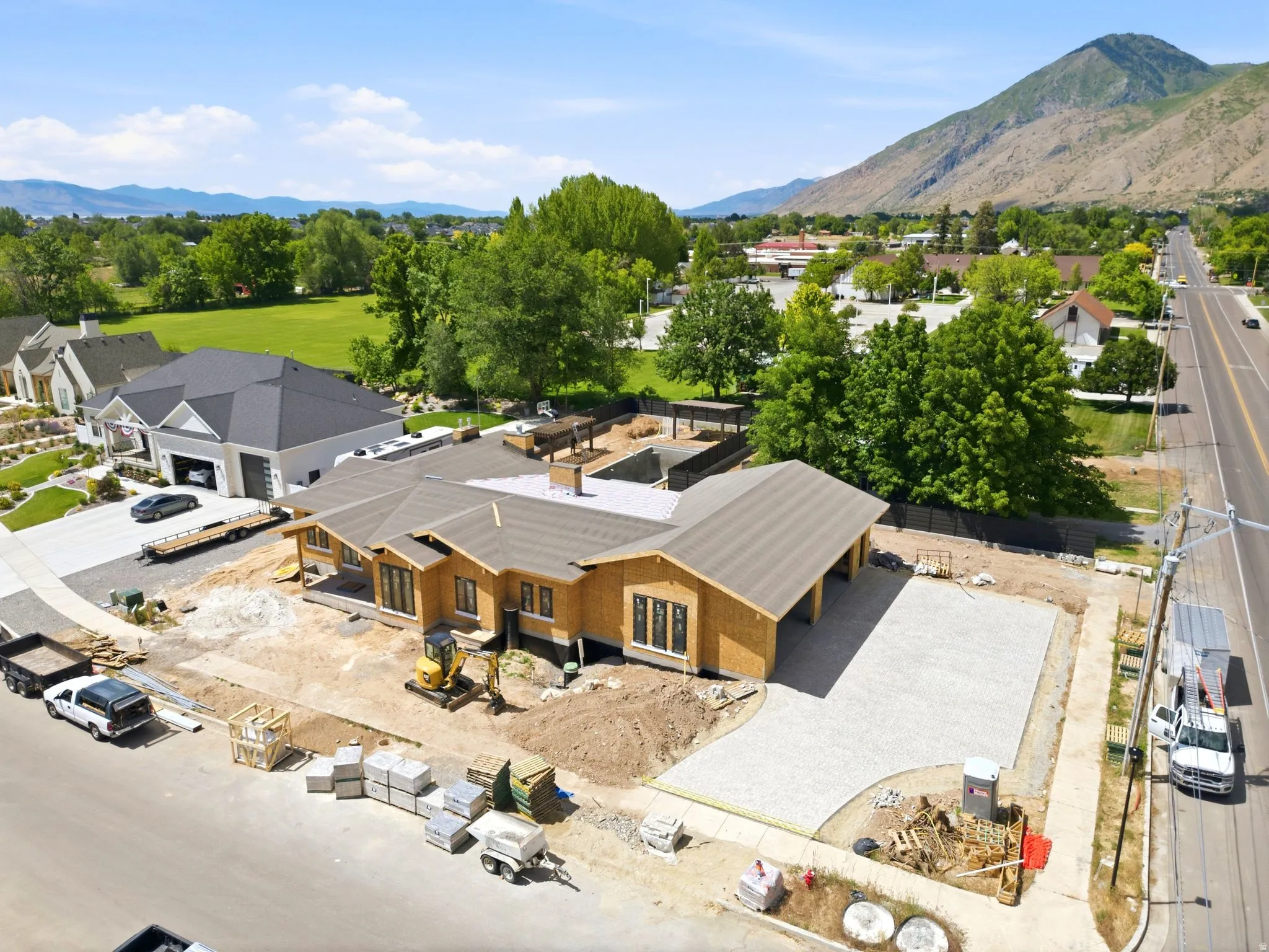 New construction property featuring a fully paved driveway with premium paver stone, offering exceptional curb appeal, durability, and a luxury finish.
