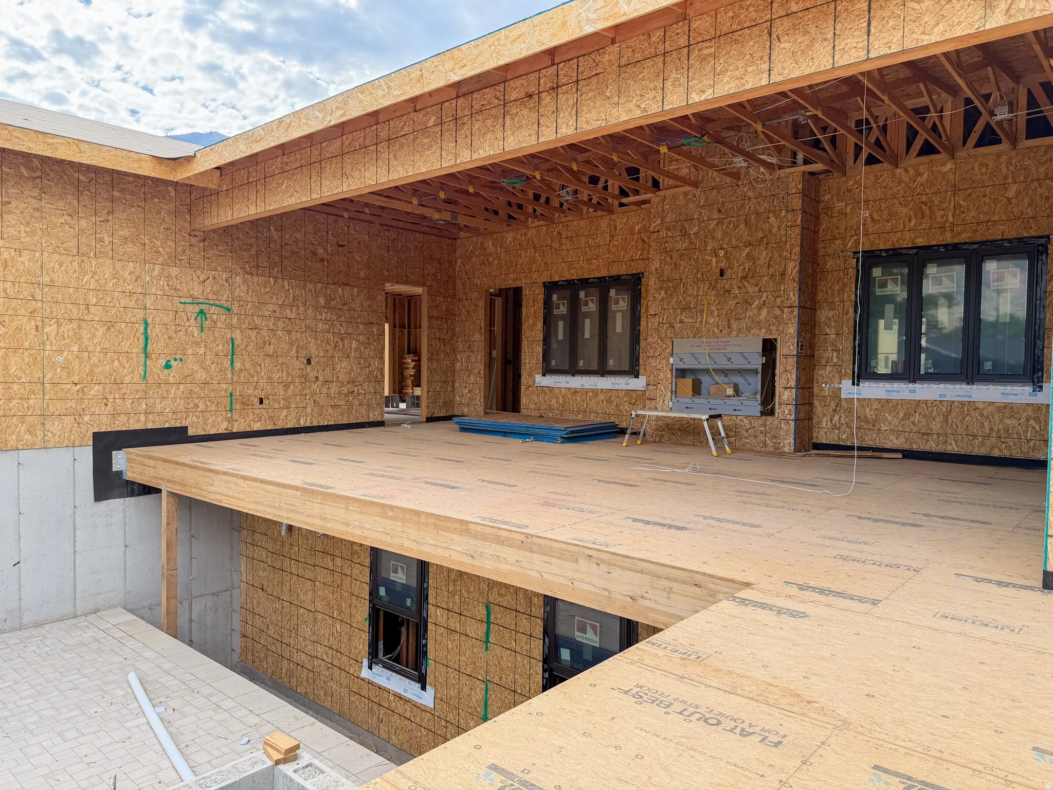 Framed structure featuring a covered outdoor living area and multiple windows