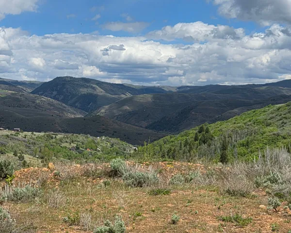 Expansive mountain landscape featuring varied terrain and distant peaks