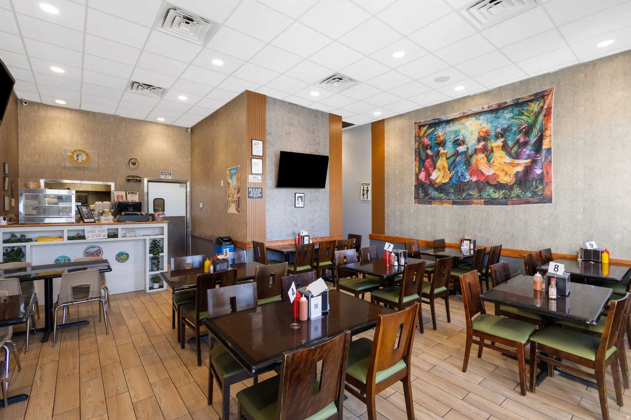 Dining area featuring wood-finish flooring and textured wall coverings