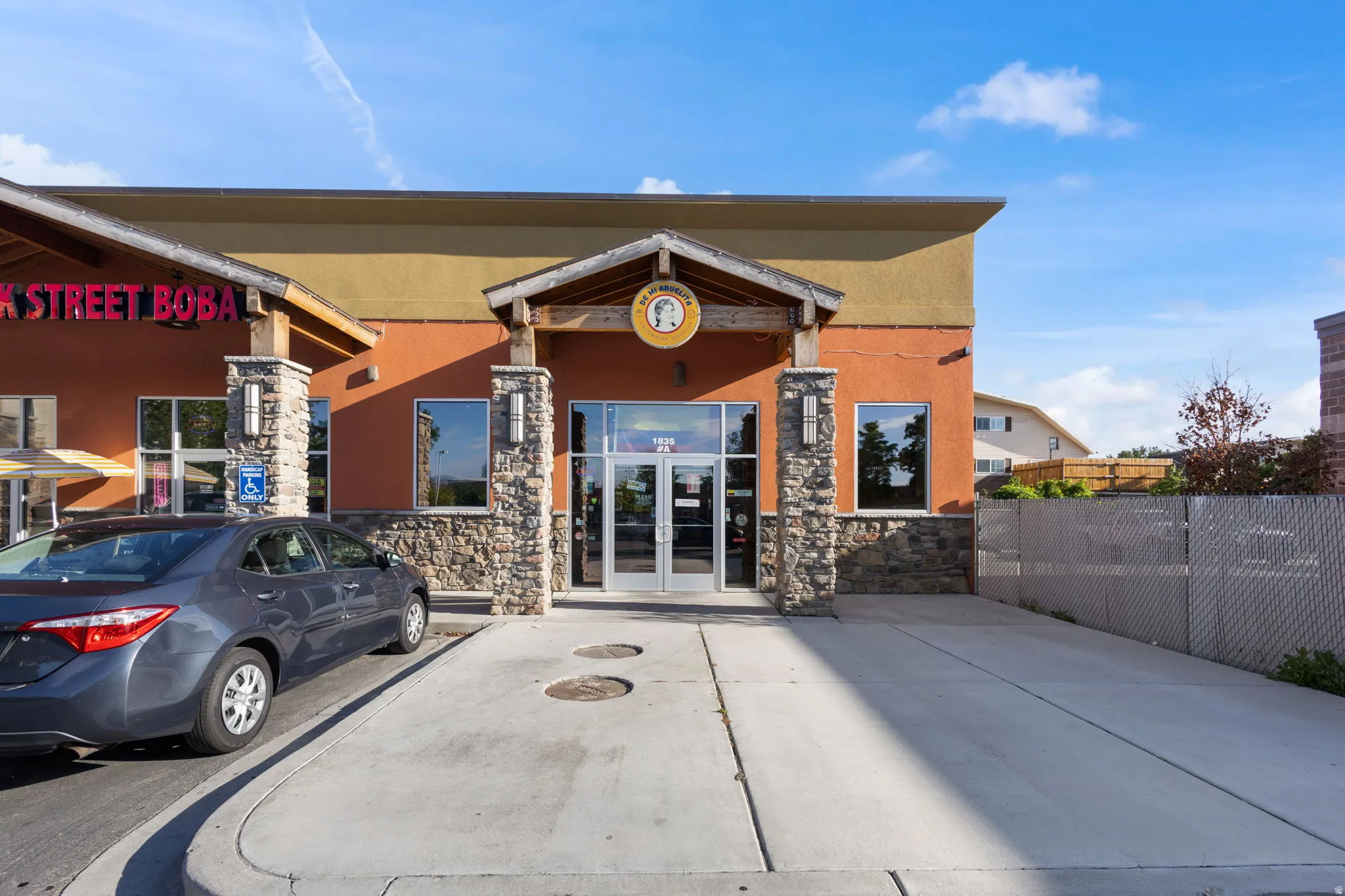 Commercial storefront featuring a stone facade and stucco exterior