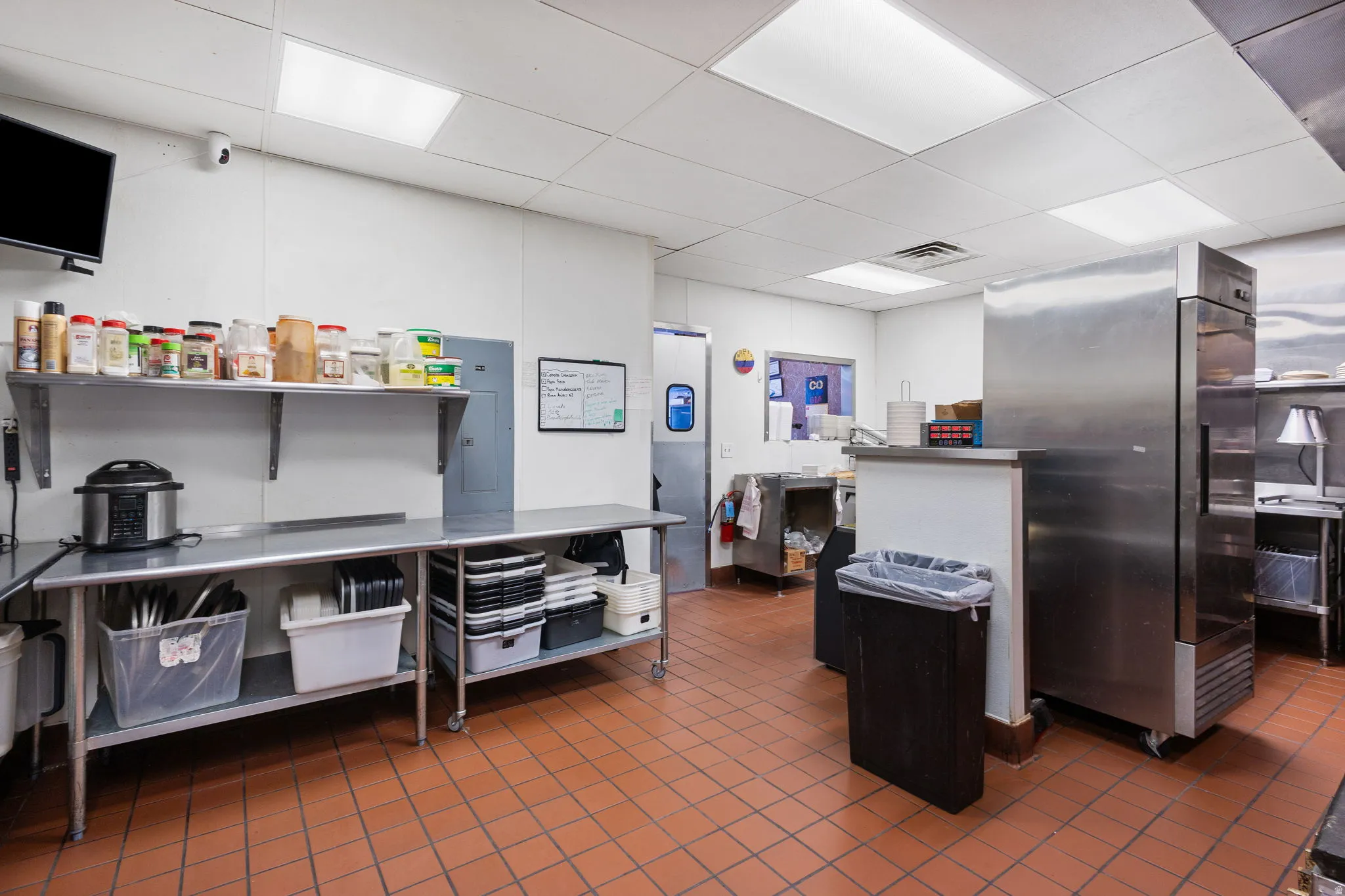 Commercial kitchen space featuring durable terracotta tile flooring