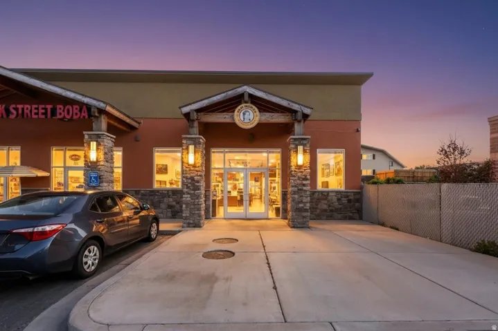 Commercial storefront with a stone column entrance and wood-beam accents