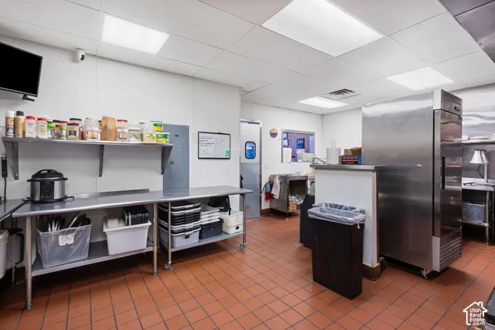 Commercial kitchen space featuring durable terracotta tile flooring