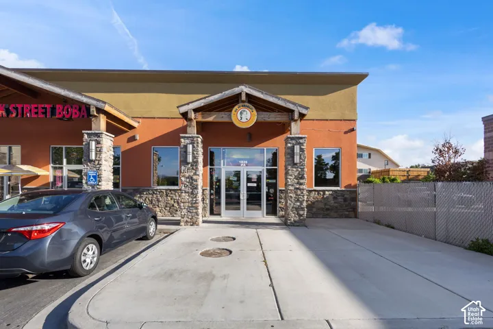Commercial storefront featuring a stone facade and stucco exterior