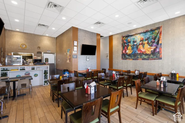 Dining area featuring wood-finish flooring and textured wall coverings