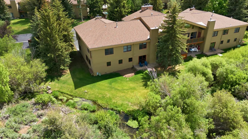 Contemporary multi-level residence featuring a stucco exterior and a shingled roof