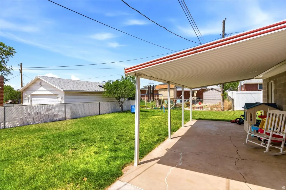 Expansive concrete patio with a covered awning