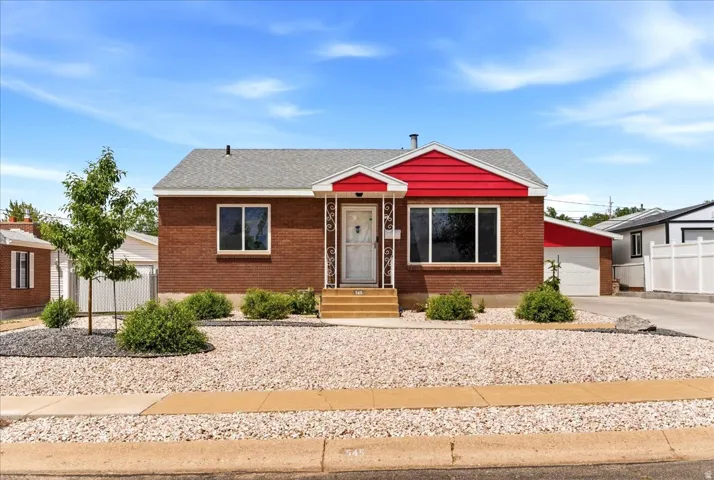 Brick exterior with red siding accents and a light gray shingle roof