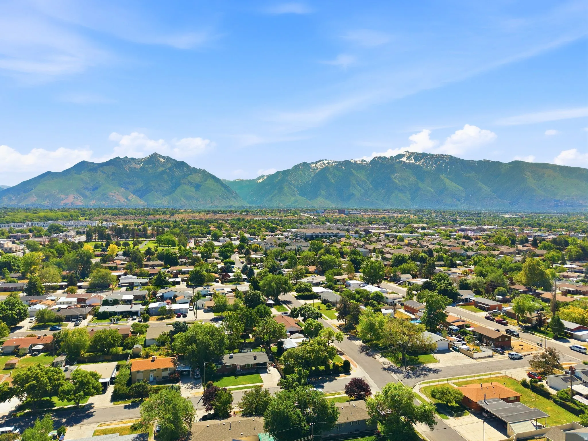 Expansive aerial view of a residential neighborhood with a mountainous backdrop