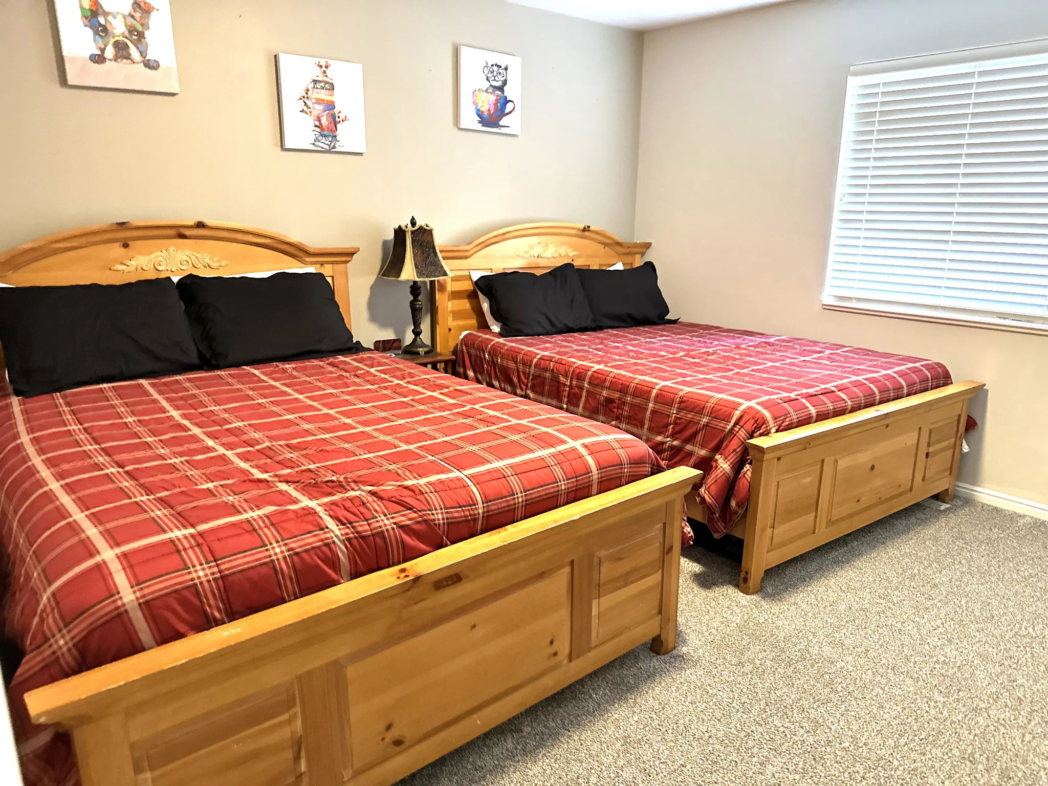 Bedroom featuring neutral wall color, light-toned carpet, and a window with blinds