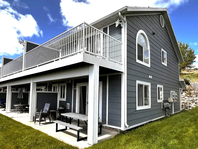 Two-story property featuring dark grey horizontal siding with white trim