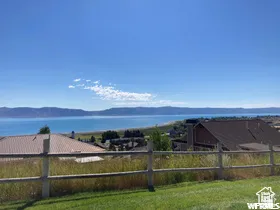 Expansive water body and distant mountains with a clear blue sky