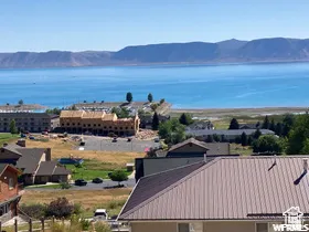 Expansive water body with distant mountains visible under a clear sky