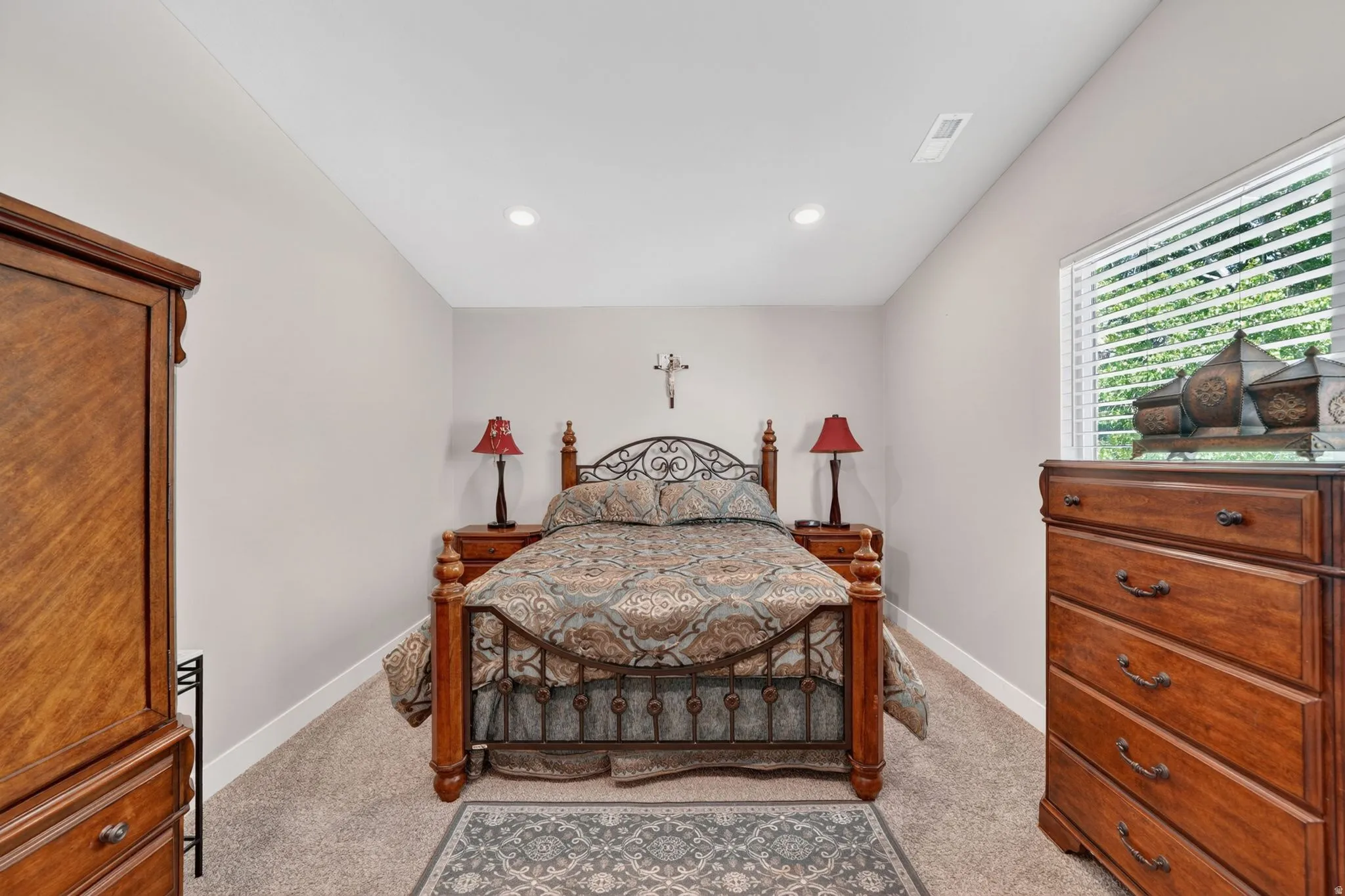 Carpeted room featuring light gray walls, a window with blinds, and recessed lighting
