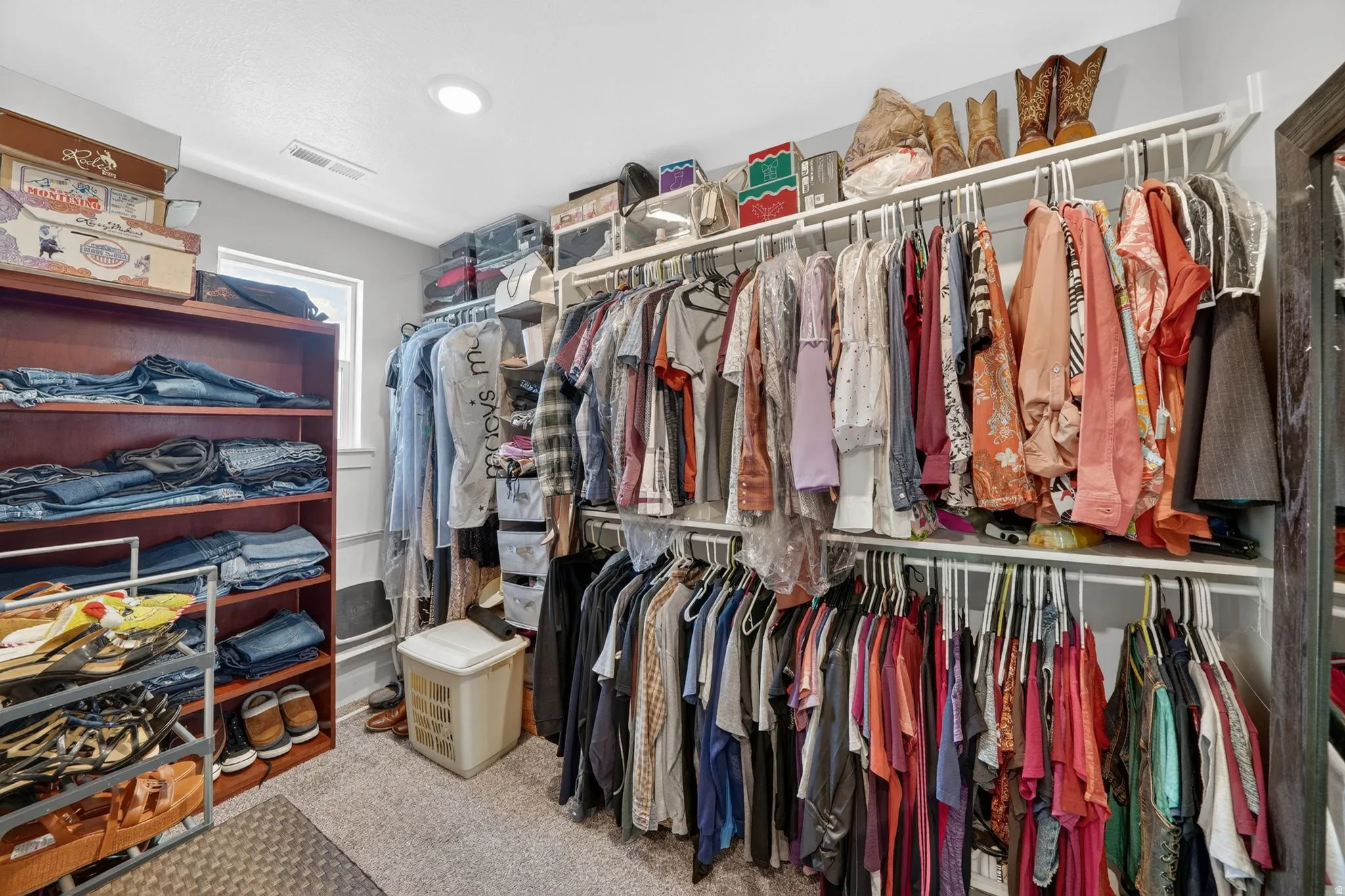Custom closet system featuring built-in shelving and multiple hanging rods