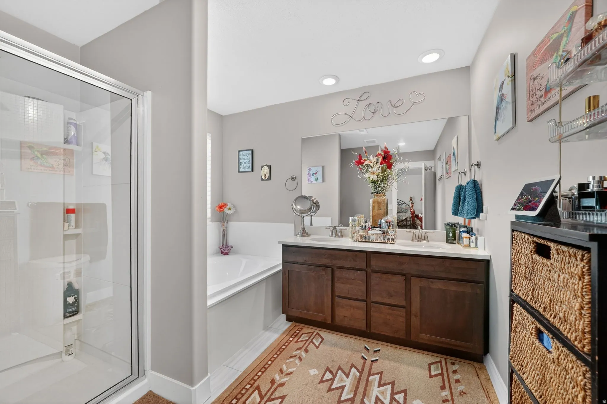 Bathroom featuring a glass-enclosed shower, built-in soaking tub, dual vanity with undermount sinks, and recessed lighting