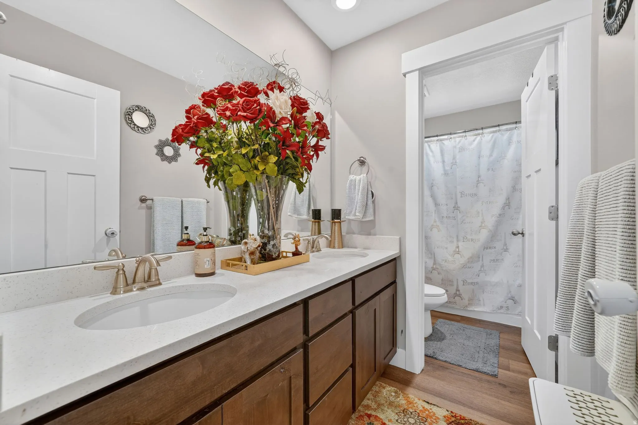 Dual vanity featuring undermount sinks, bronze-finish faucets, and a light-toned countertop