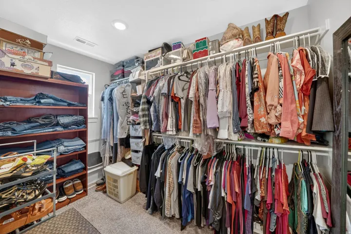 Custom closet system featuring built-in shelving and multiple hanging rods
