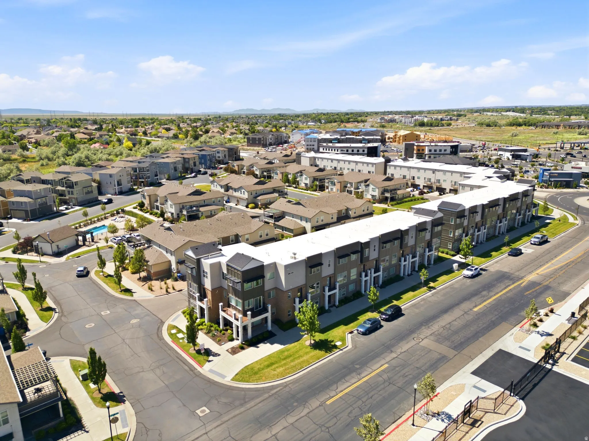 Contemporary multi-story townhomes and residences featuring varied exterior finishes