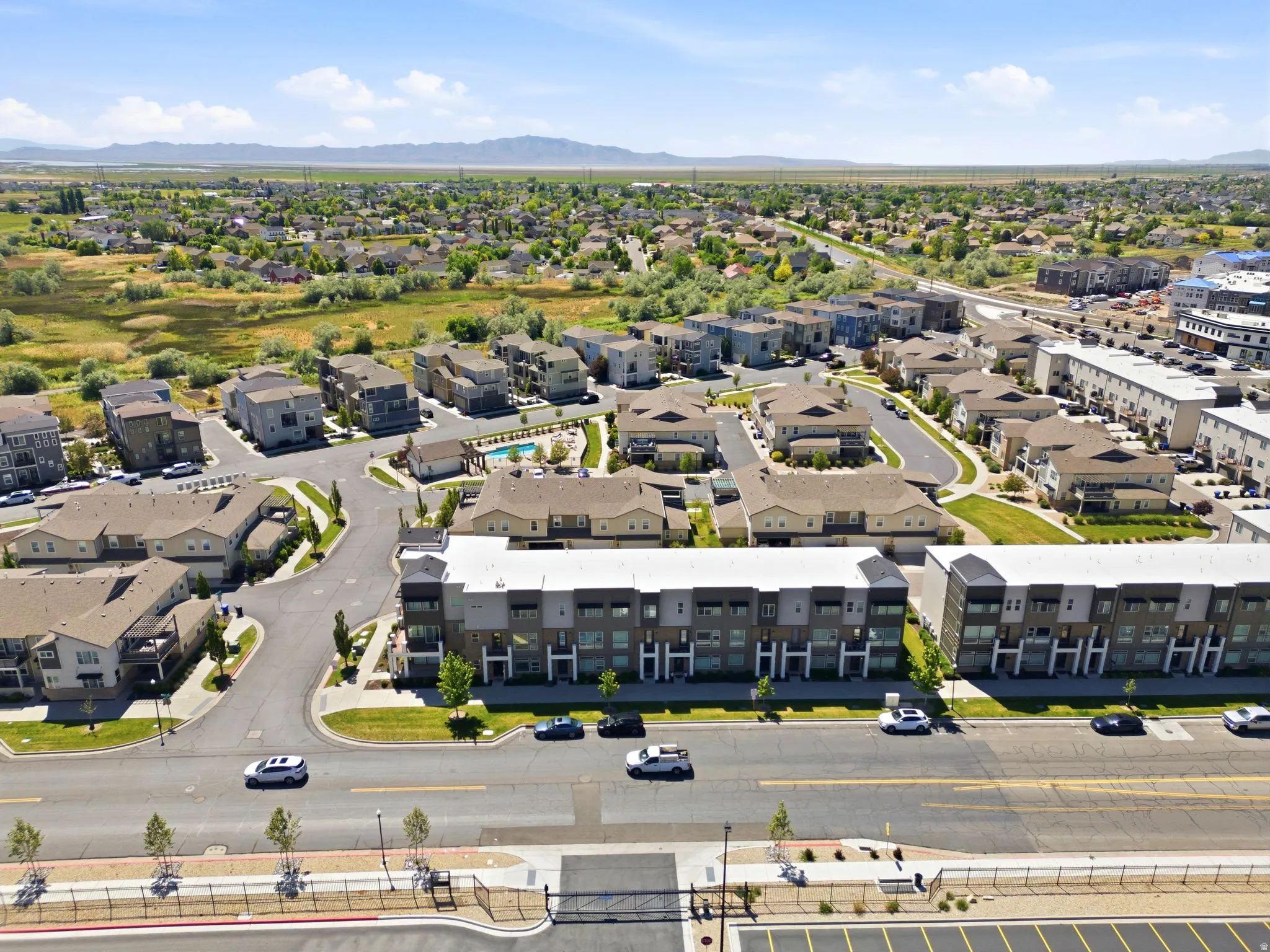 Expansive aerial capturing a contemporary residential development with varied architectural styles