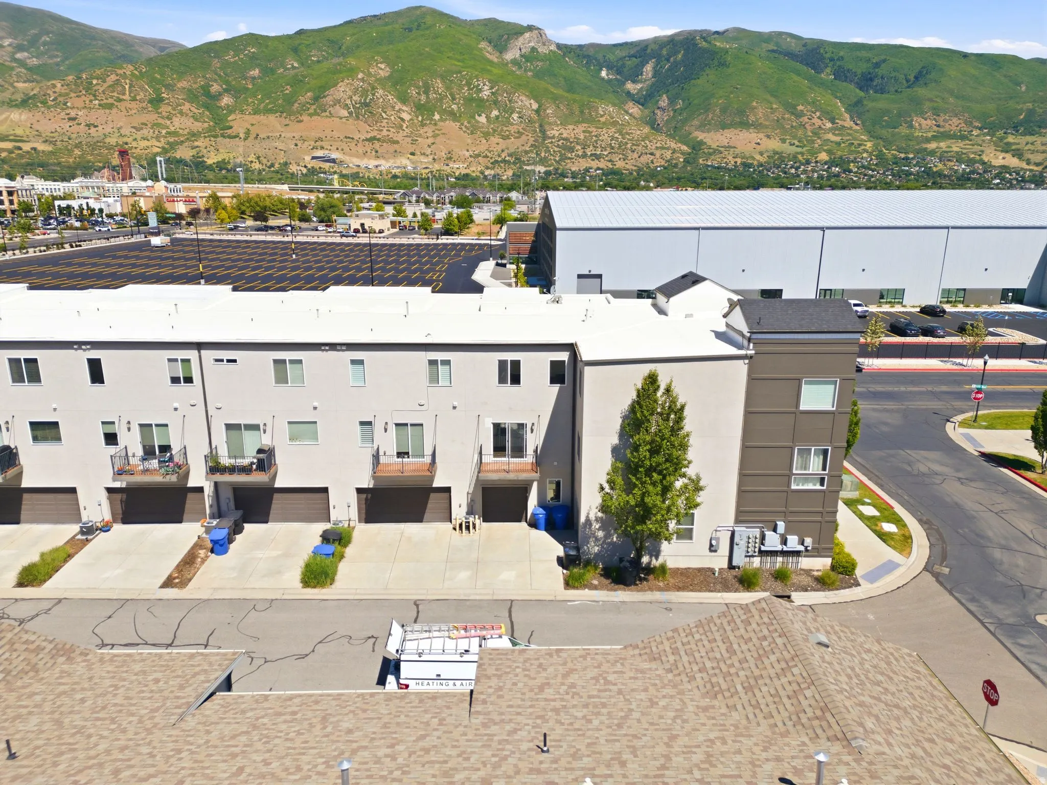 Modern townhome-style units featuring balconies, ground-level garages, and contemporary exterior finishes