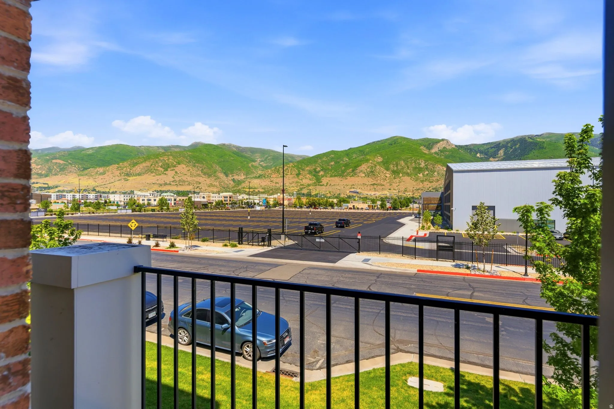 Balcony with black metal railing and brick column