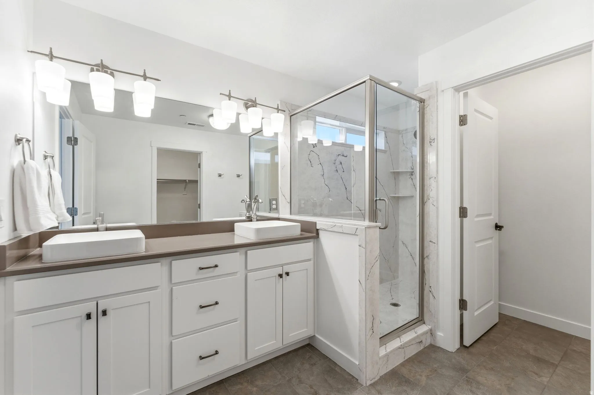 Modern bathroom featuring a dual vanity with rectangular vessel sinks and brushed nickel fixtures