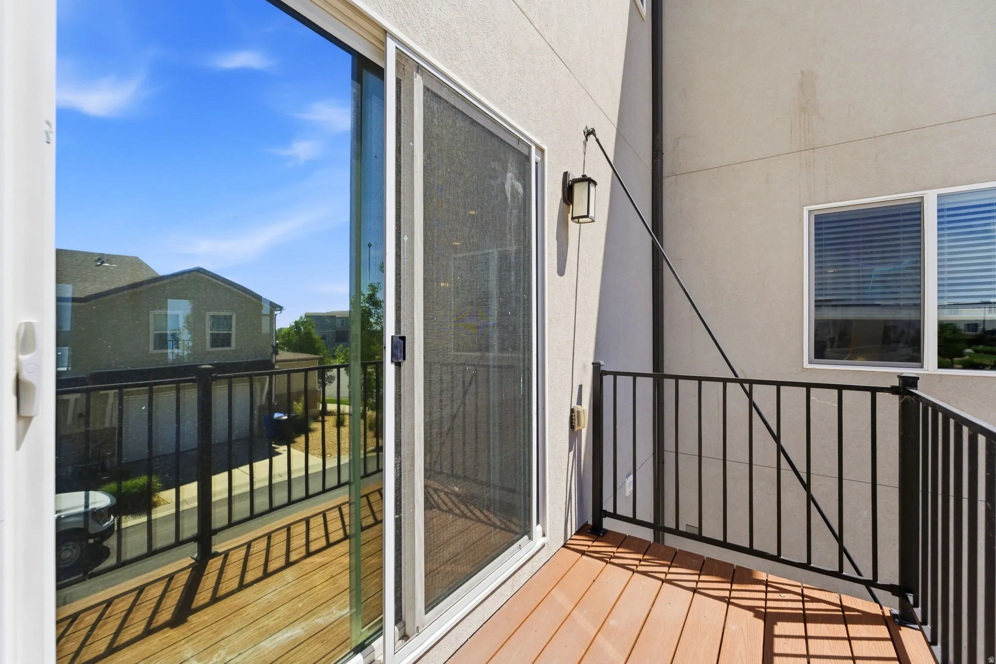 Private balcony featuring composite decking and black metal railing