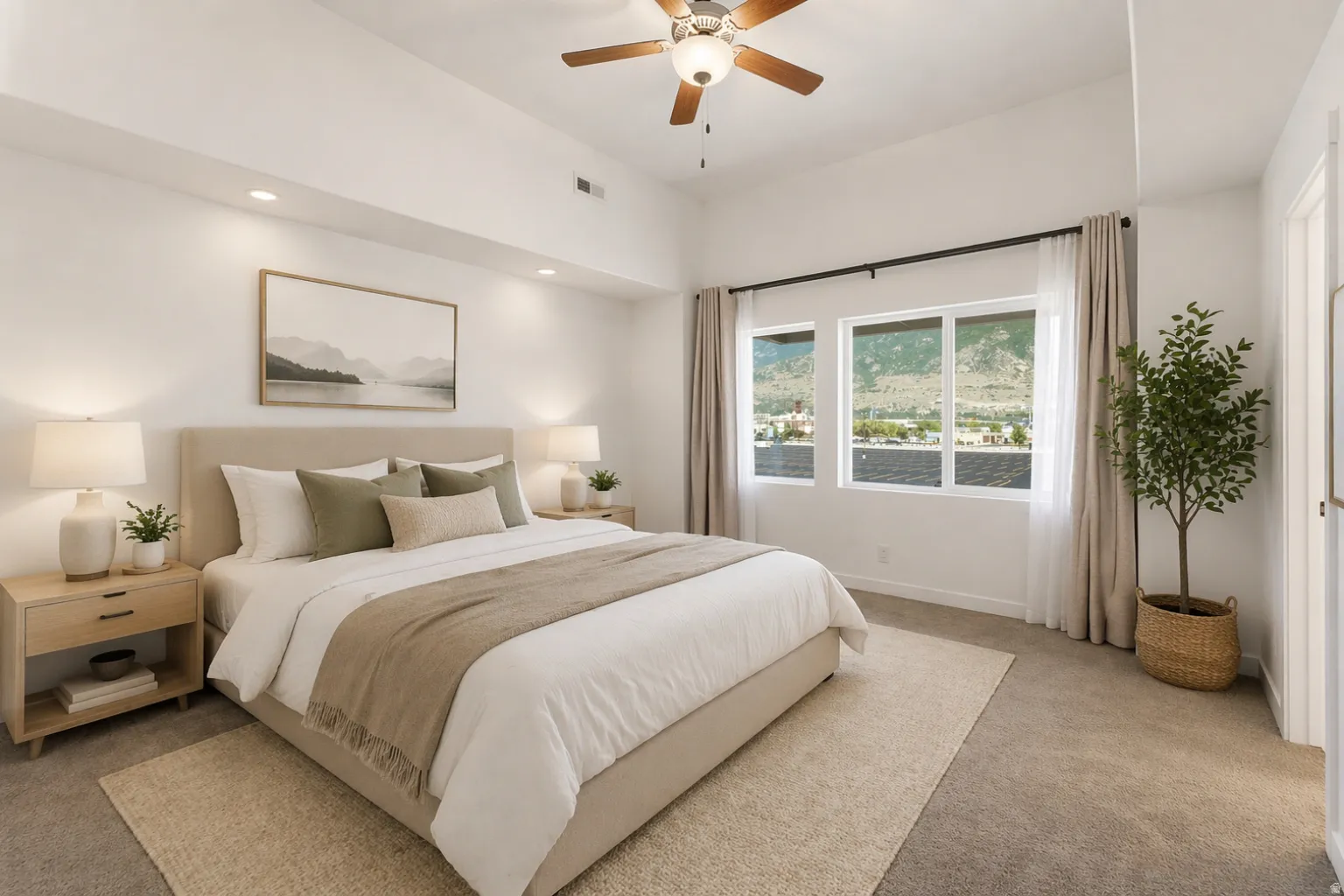 Bright bedroom featuring an upholstered bed frame, recessed lighting, and a ceiling fan