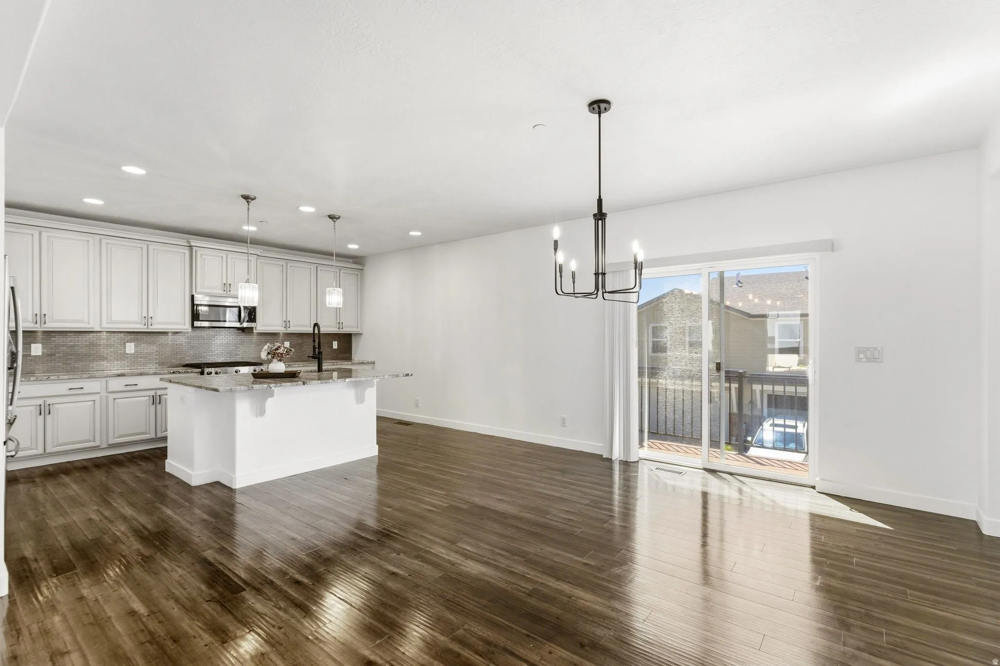 Open-concept living space with wood-finish flooring