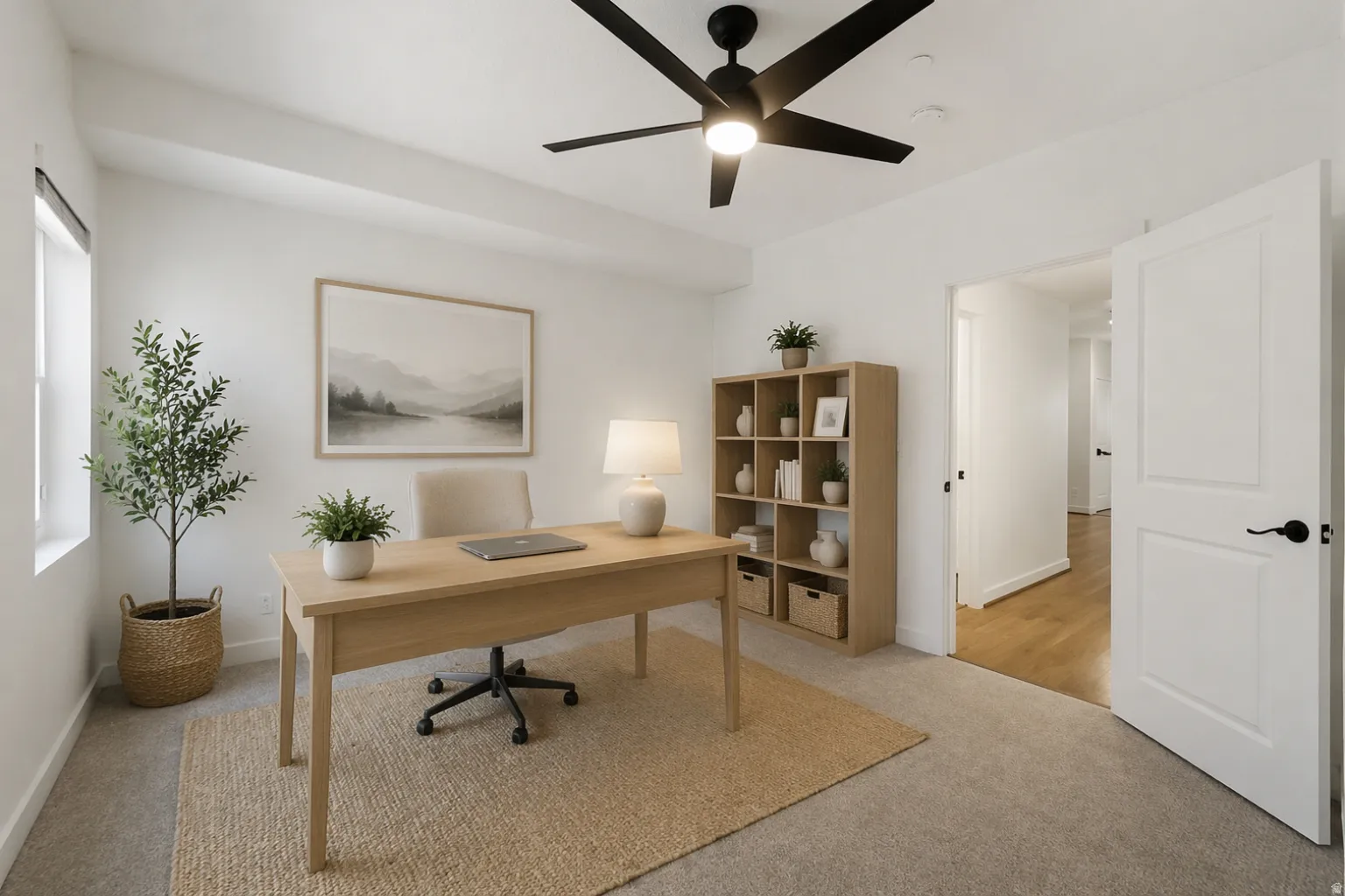 Inviting room featuring a modern ceiling fan with integrated lighting, a substantial window for natural light, and a white paneled door with matte black hardware