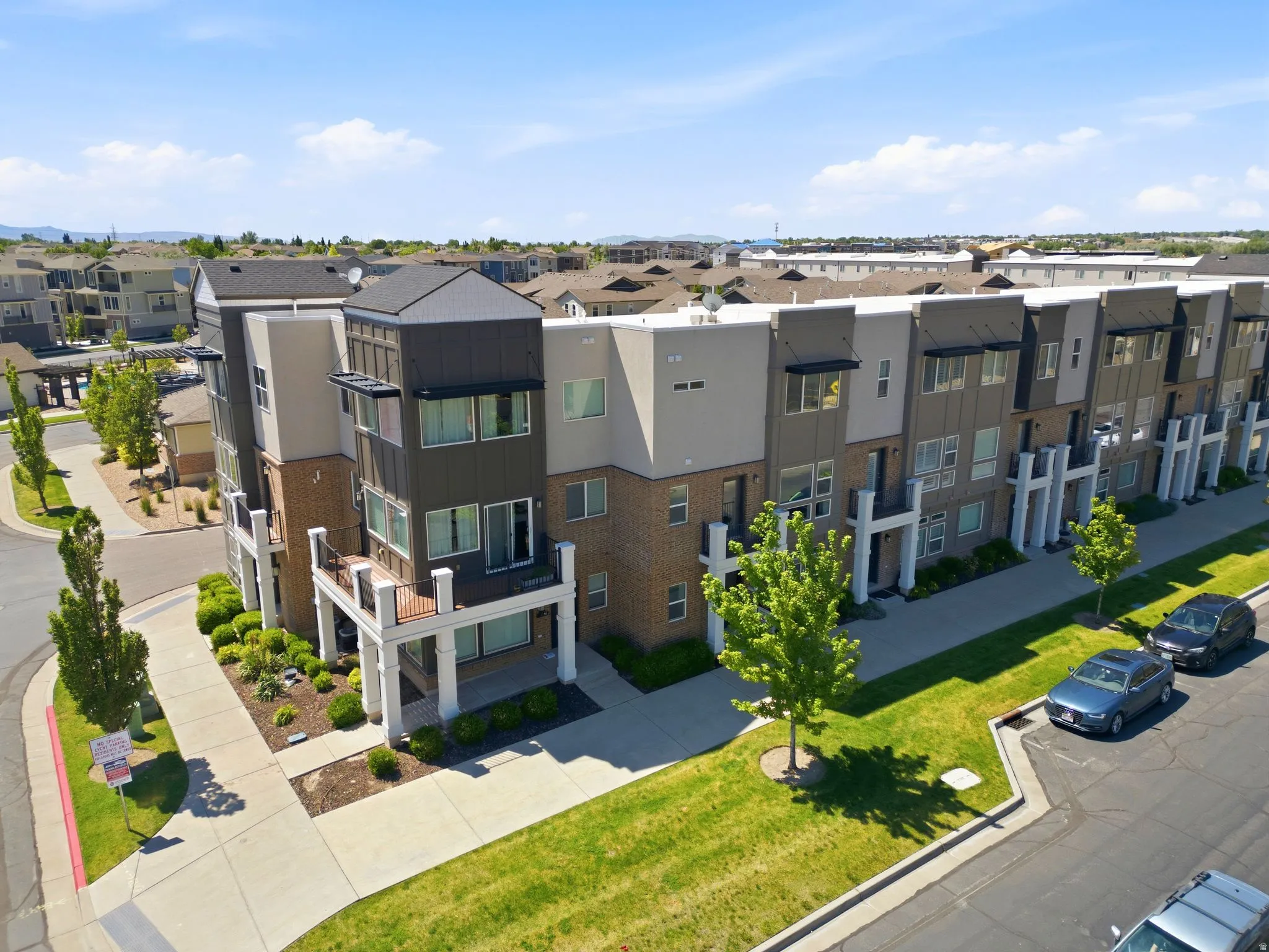Modern townhome building featuring a multi-tone facade with brick and horizontal siding