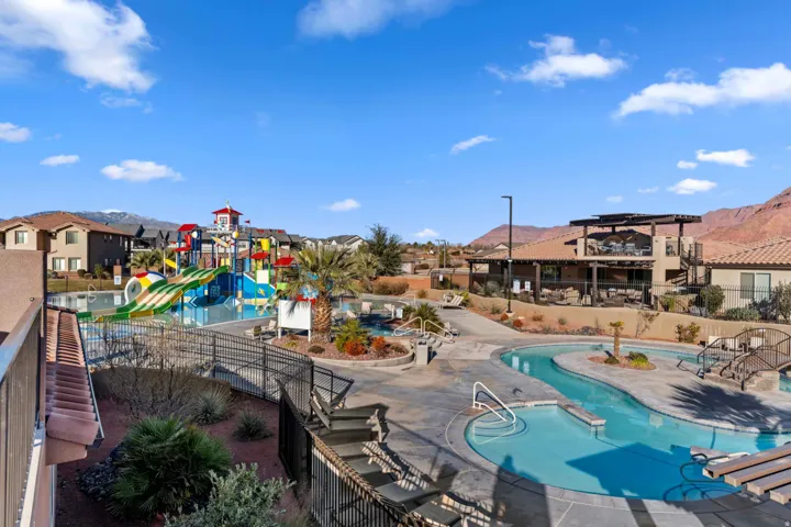 Community pool area featuring a lazy river, water park structure, and expansive sundeck